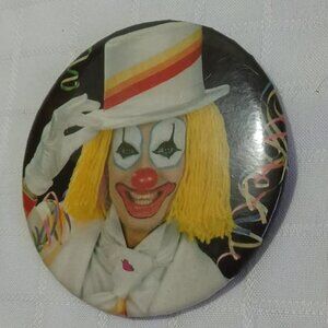 Strange & unusual vintage button pin featuring a yellow haired clown